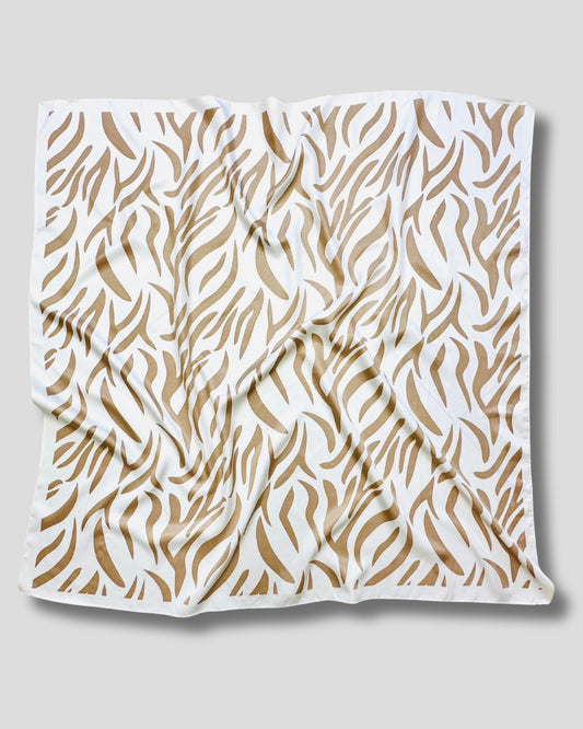 White scarf with brown abstract pattern on a light gray background
