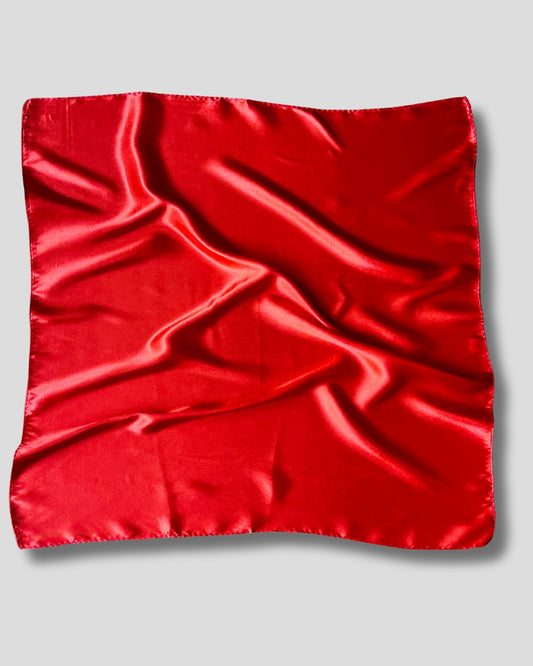 Red satin square scarf on a gray background