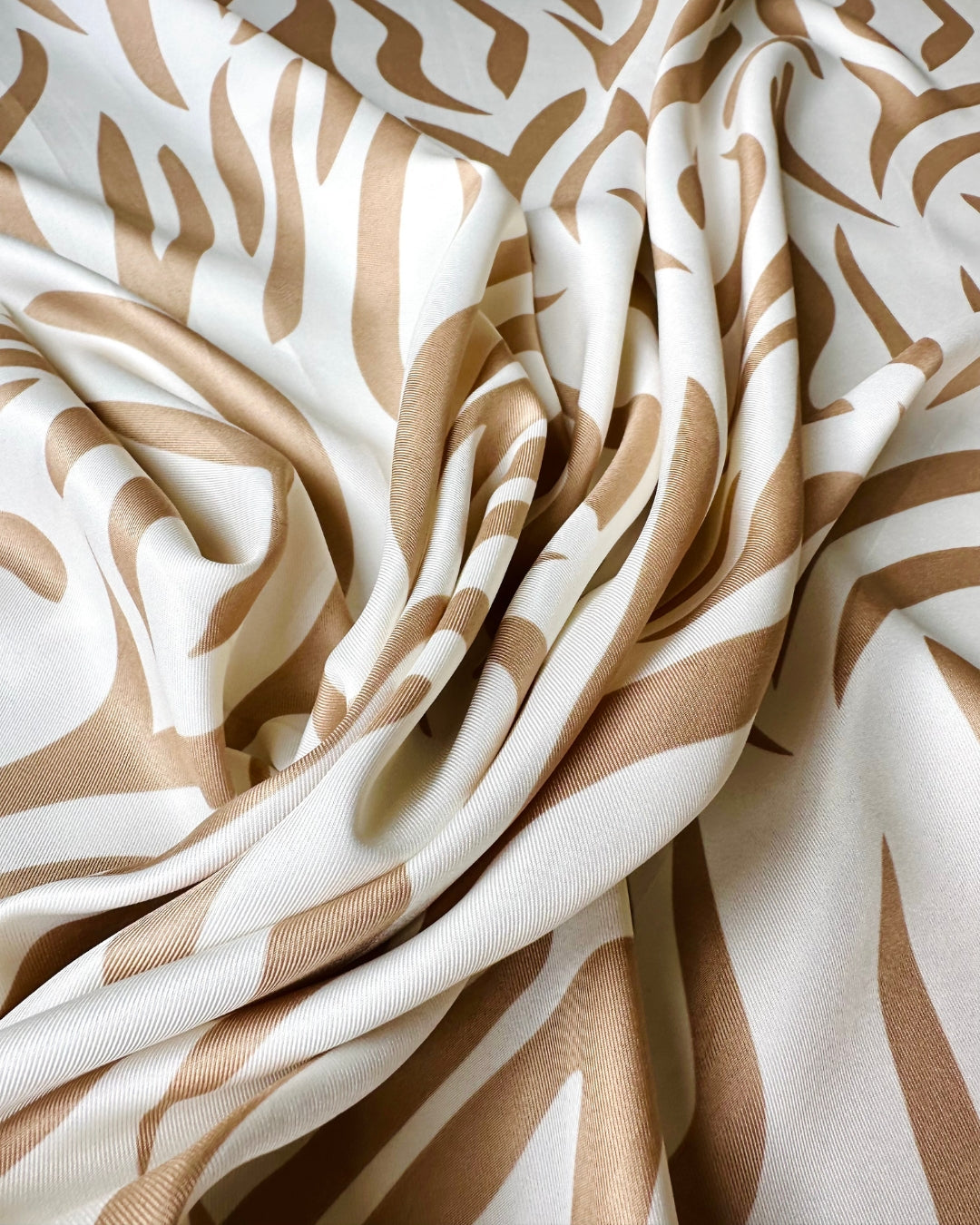 Close-up of scarf fabric with brown and white pattern