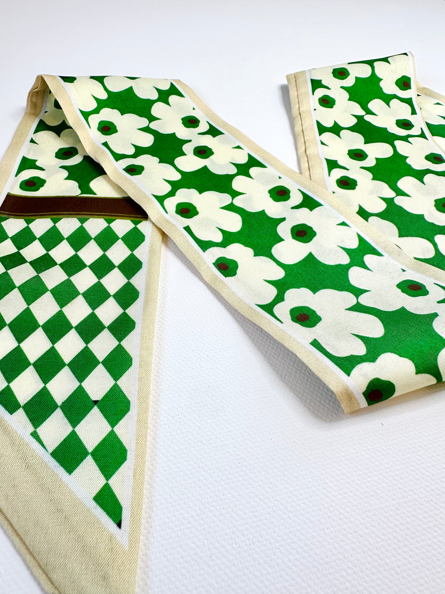 Ribbon scarf with green and white patterns on a white background