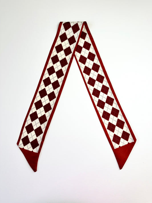 Checkered ribbon scarf with red and white pattern on a white background