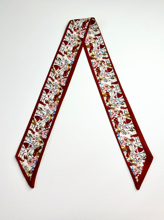 Decorative ribbon scarf with cartoon character pattern on a white background