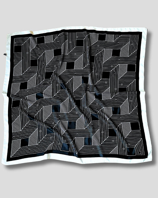 Black and white geometric patterned fabric on a light gray background