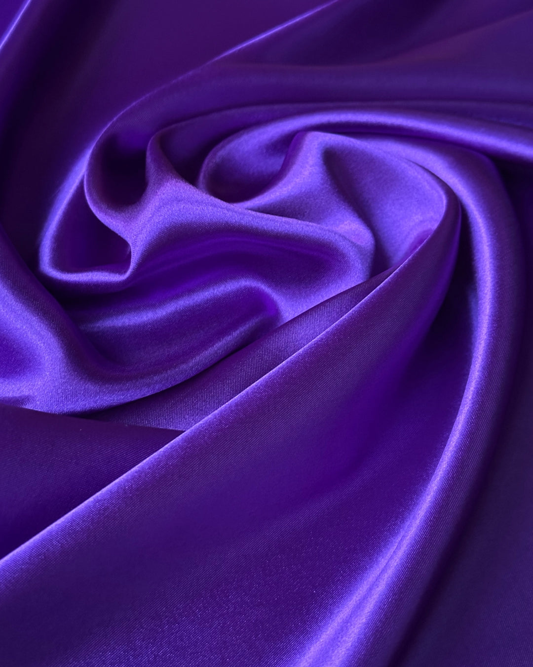 Close-up of purple scarf fabric with a smooth texture