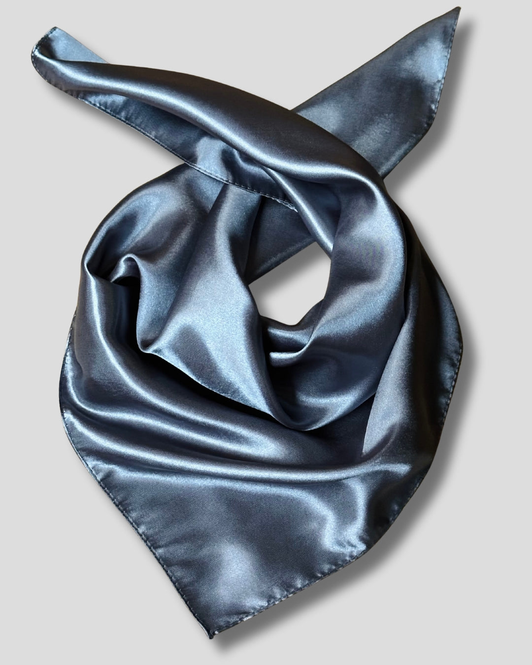Gray satin scarf folded on a light gray background