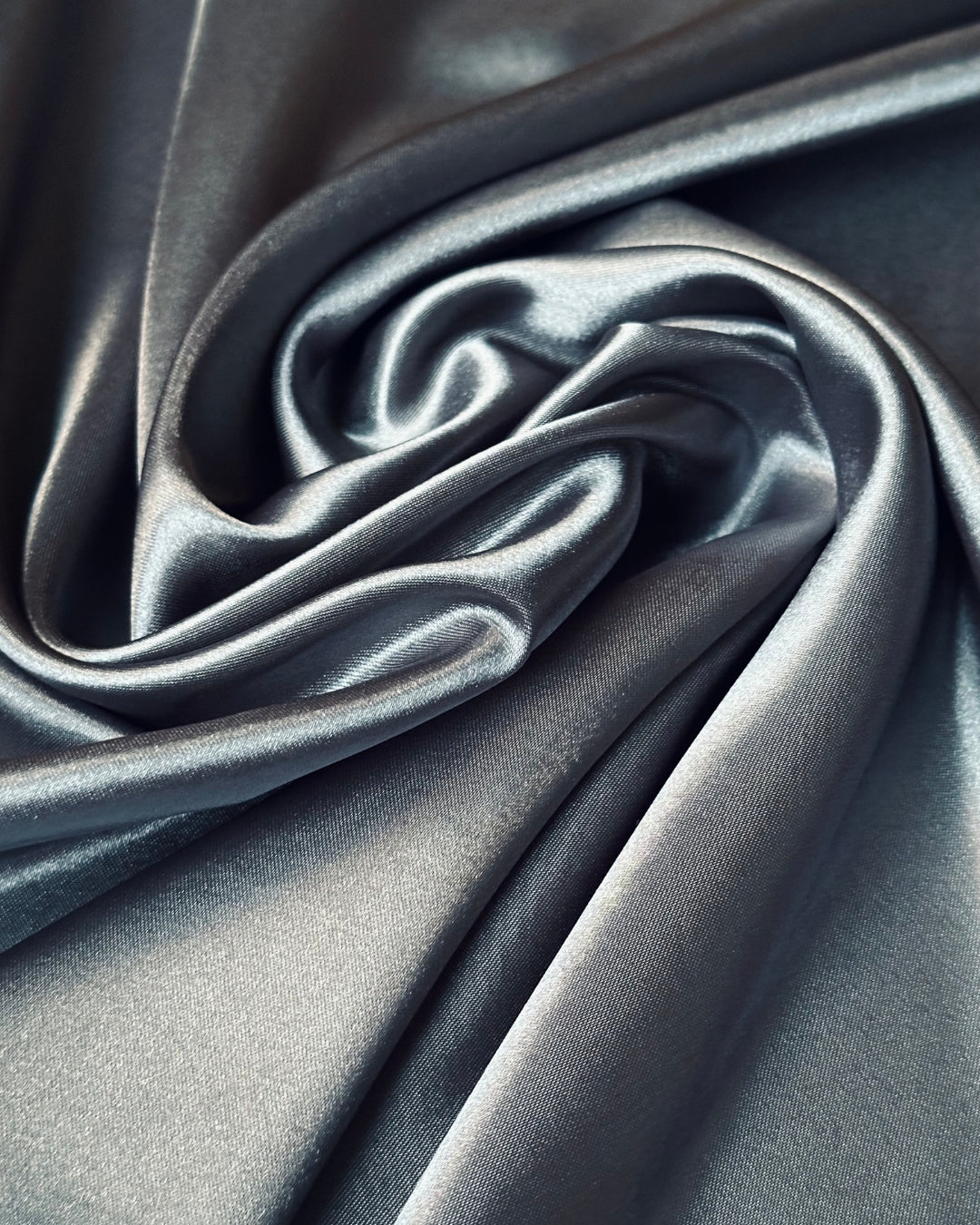 Close-up of gray scarf fabric with folds