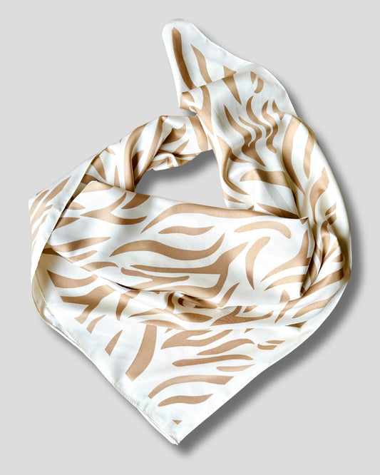 White scarf with brown abstract pattern on a light gray background