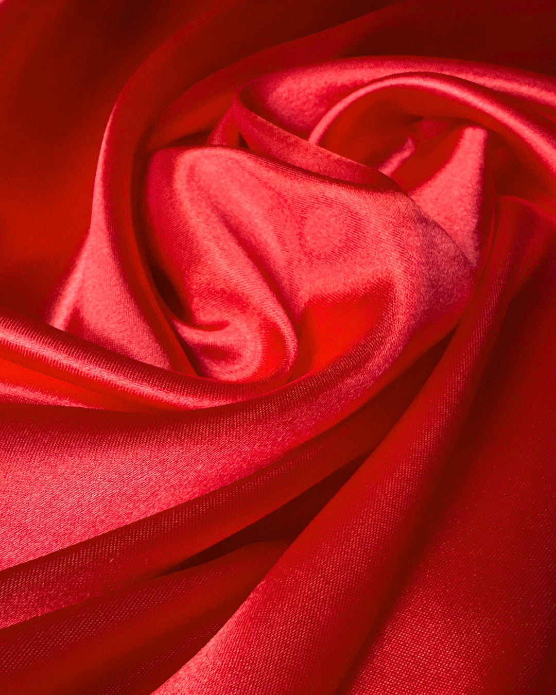 Close-up of red scarf fabric with folds