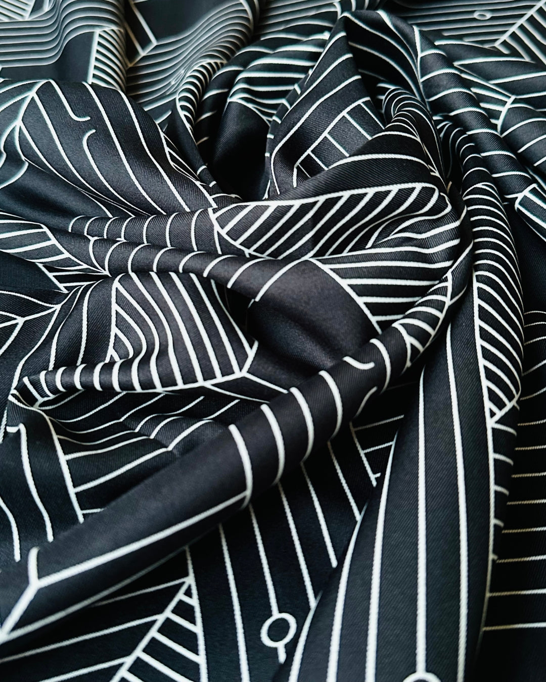 Black scarf fabric with white geometric patterns