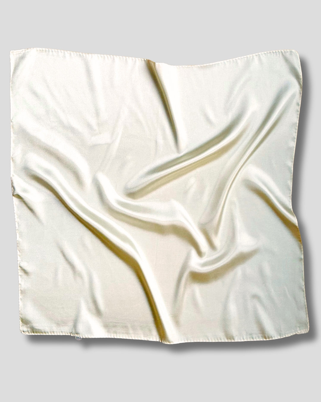 White satin square scarf on a gray background
