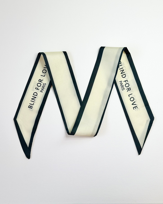 Ribbon scarf with 'Blind for Love' branding on a white background