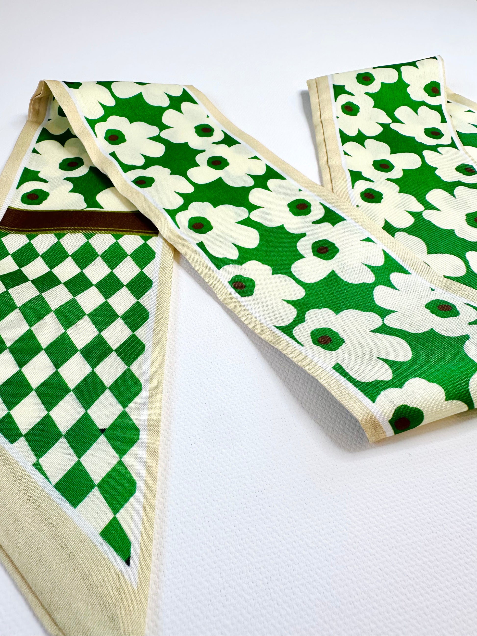 Ribbon scarf with green and white patterns on a white background