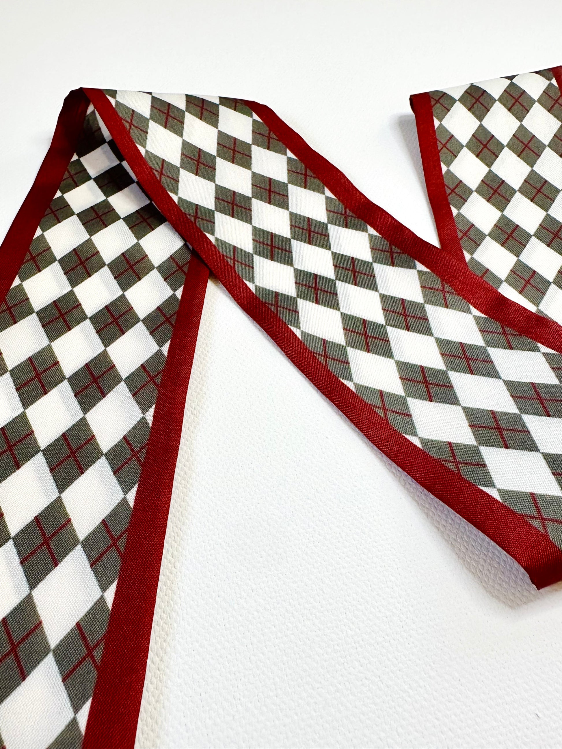 Checkered pattern and red border scarf on a white background