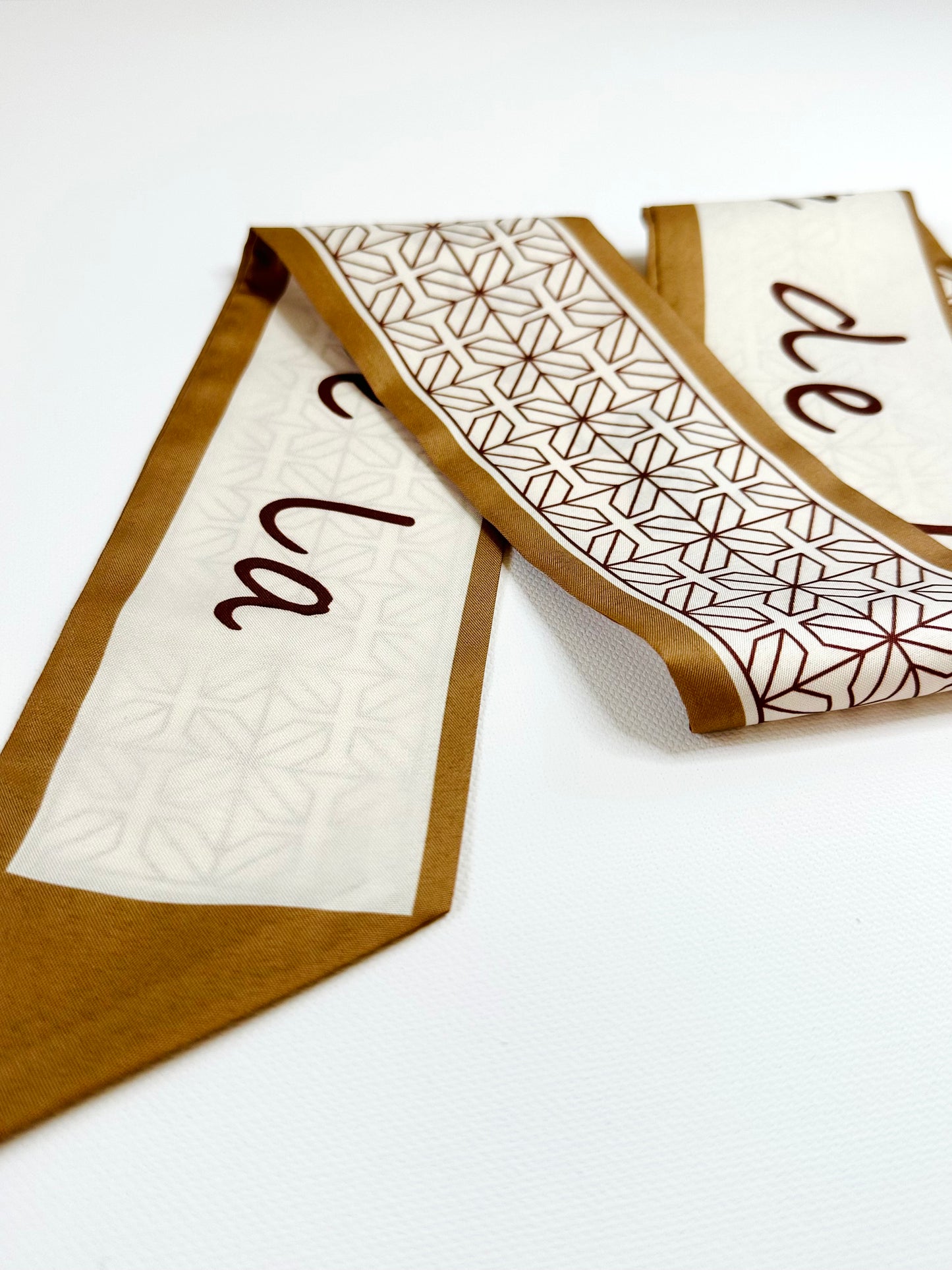 Two patterned ribbon scarf on a white background