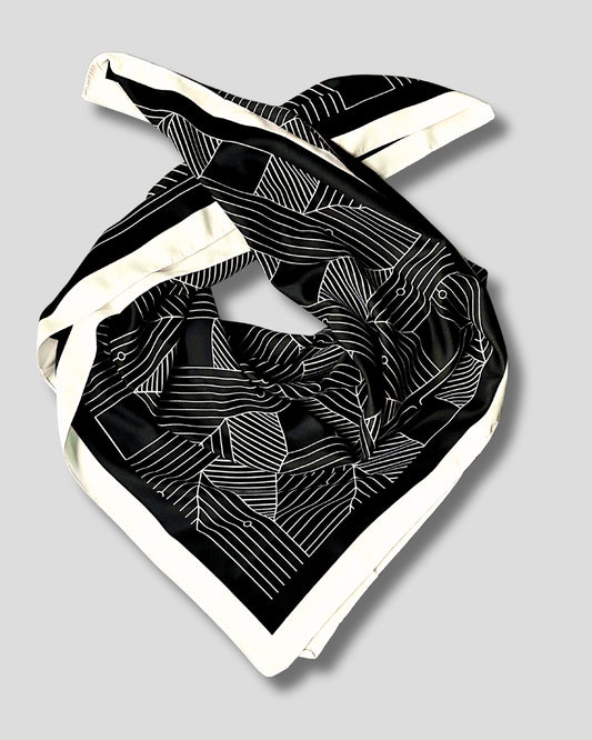 Black and white patterned scarf on a light gray background